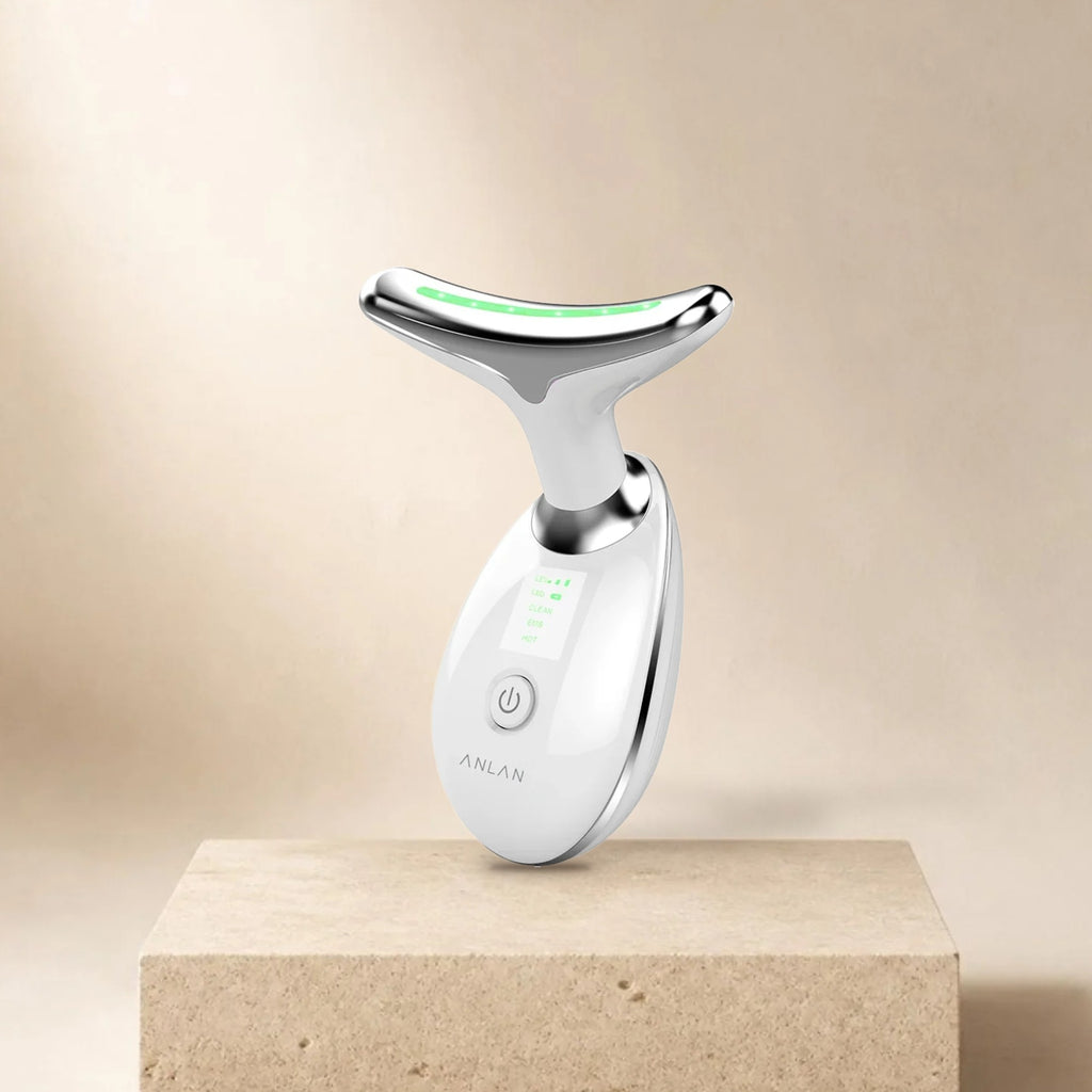 Appareil soin cou et visage ANLAN (nettoyage, EMS, chaleur) posé sur un socle en pierre, fond beige
