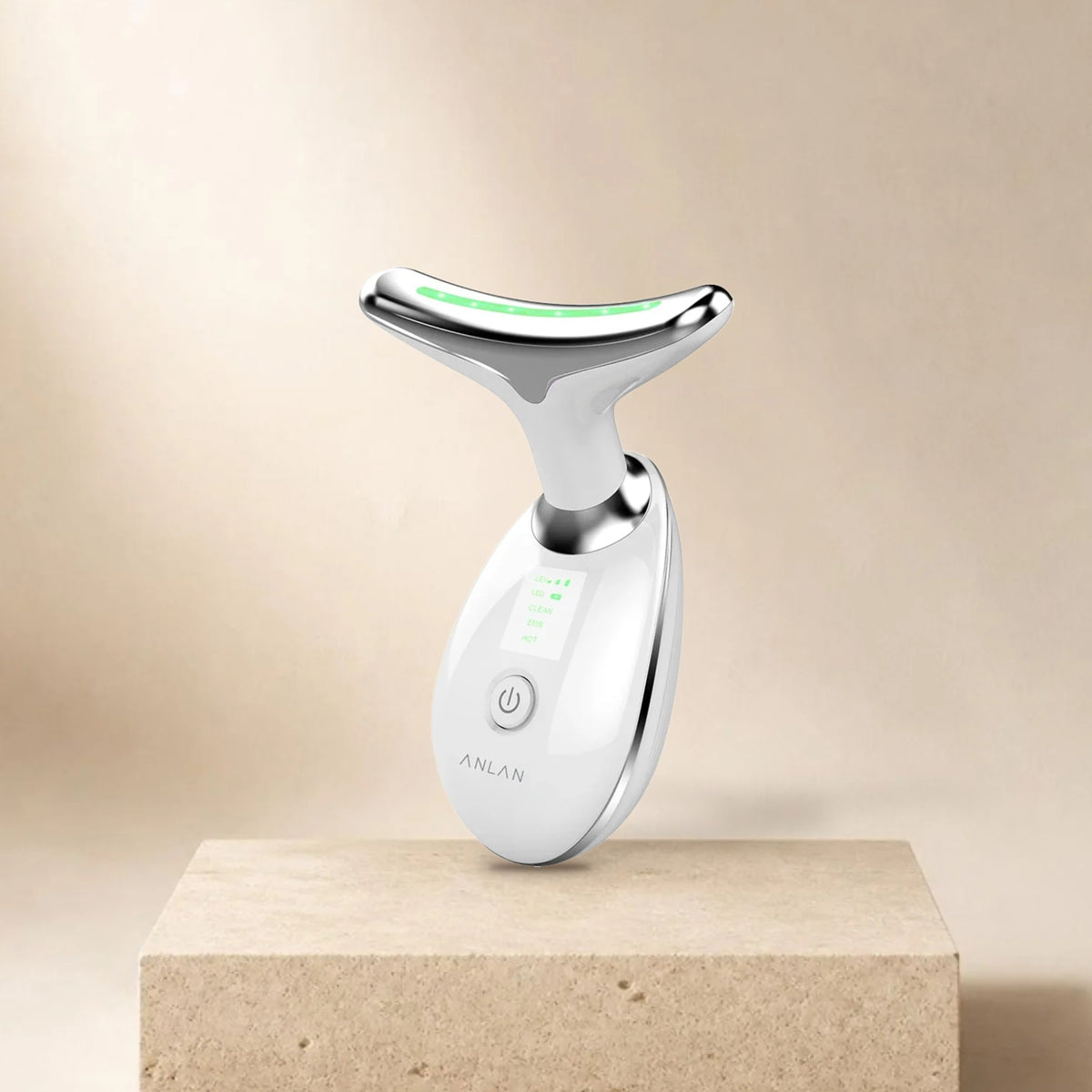 Appareil soin cou et visage ANLAN (nettoyage, EMS, chaleur) posé sur un socle en pierre, fond beige